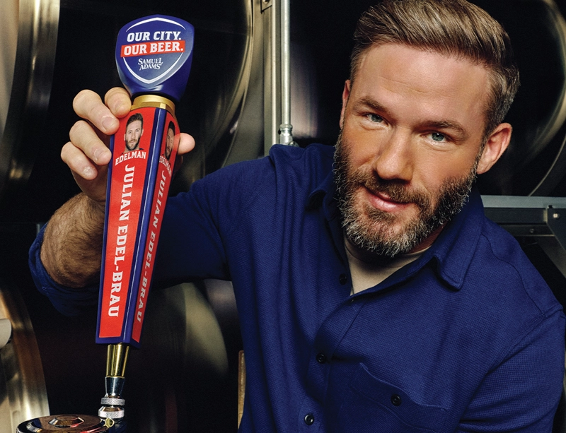 Julian Edelman pouring a Julian Edel-brau beer from a tap handle