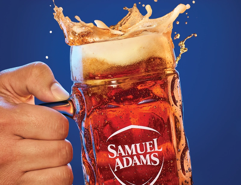 hand holding a stein of Sam Adams Octoberfest beer